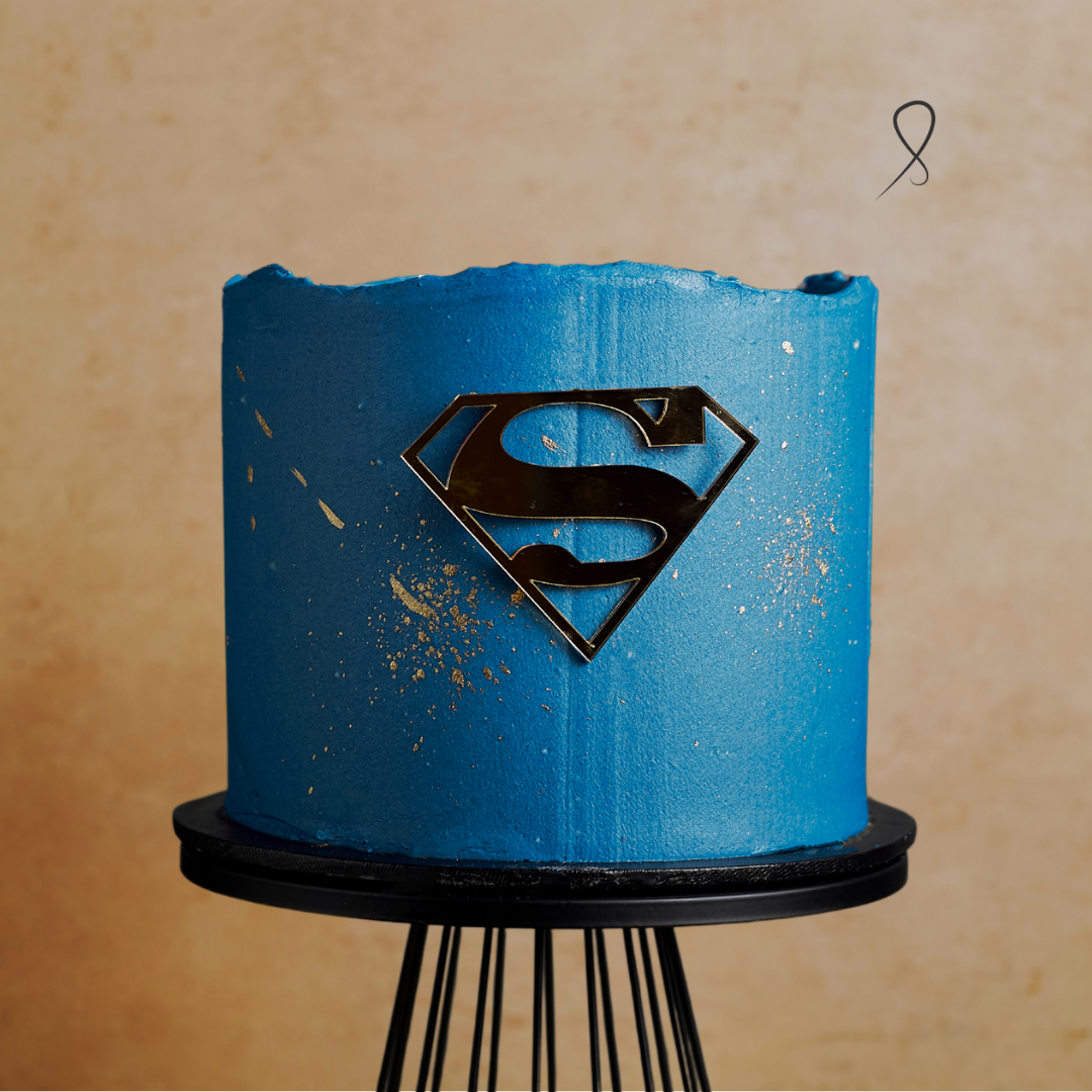 Father’s Day cake in Hero Blue buttercream with gold S topper – custom Super Dad Cake by The Sweet Layers Factory